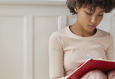 mulher sentada no chão praticando escrita criativa